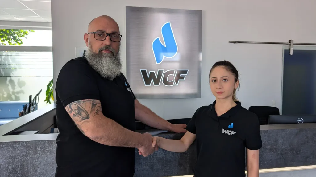 Michael König shakes hands with the new apprentice Alevtina Curdova.